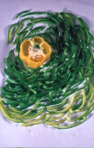 Duplicate or near-duplicate of the bell pepper spiral composition, showing a yellow bell pepper center surrounded by a swirl of green and yellow pepper slices.